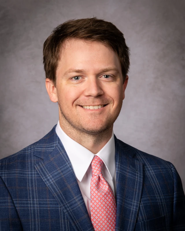 Professional man in blue plaid suit smiling